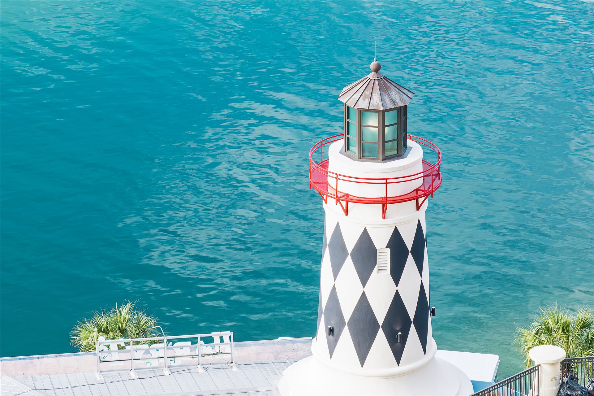 lighthouse near edge of salt water - lighthouse near edge of salt water red railing looking down at lighthouse by Terry Kelly Photography