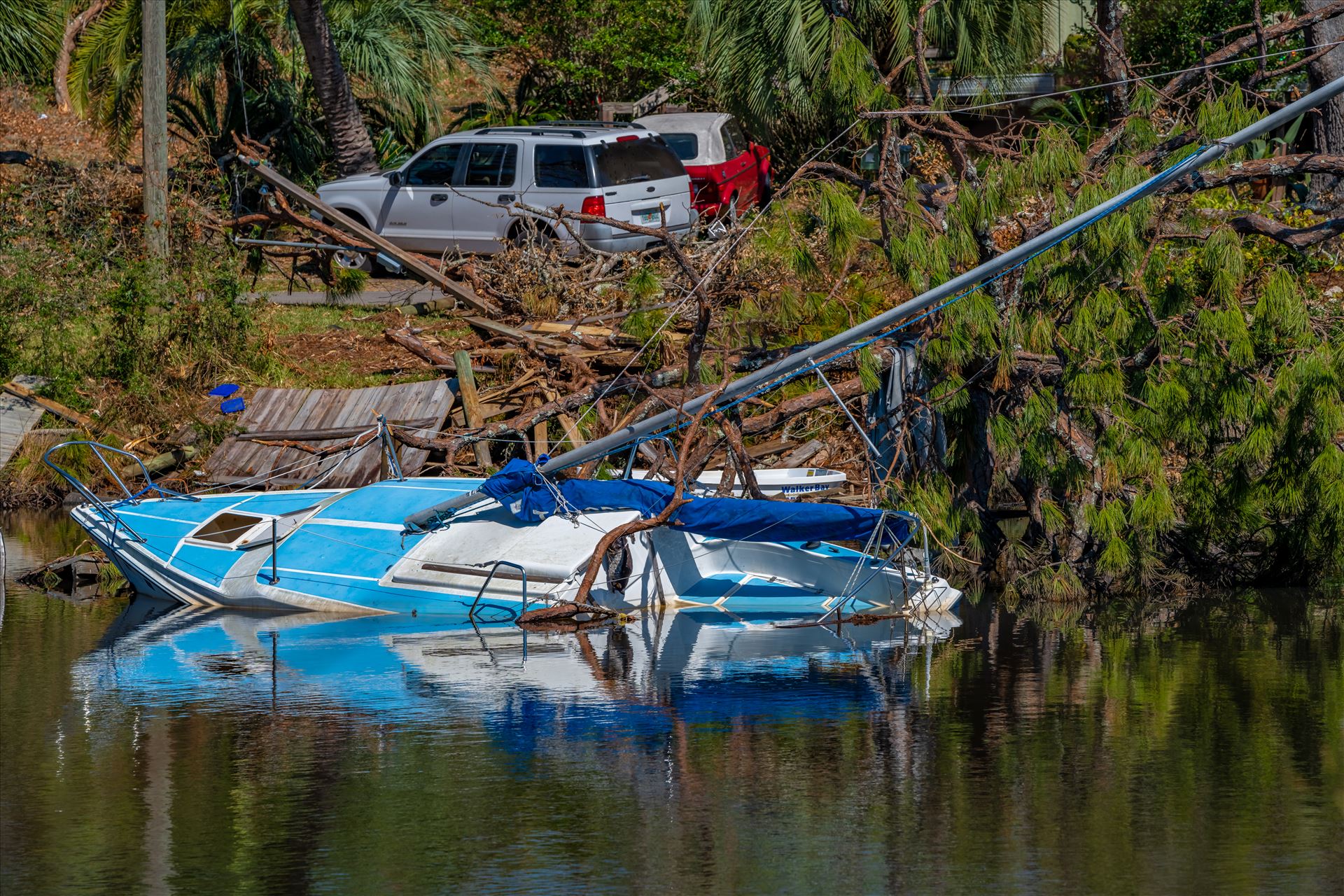 Hurricane Michael - Massalina bayou, Panama City, Florida. sunken sailboat from hurricane Michael by Terry Kelly Photography