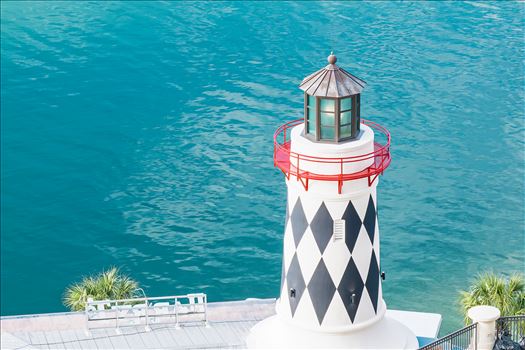 lighthouse near edge of salt water red railing looking down at lighthouse