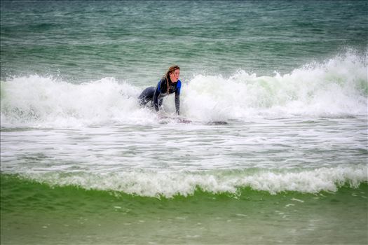 Female surfer at St. Andrews State Park at the jetties