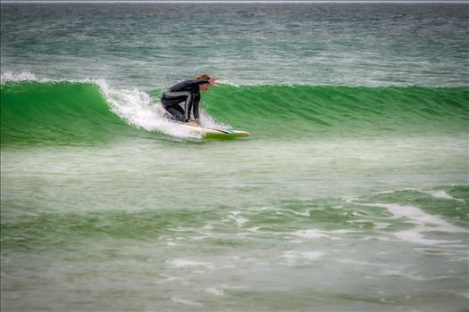 Female surfer at St. Andrews State Park at the jetties